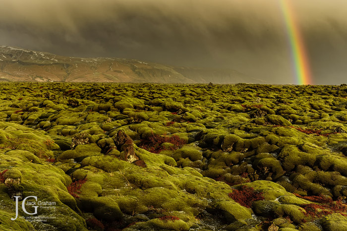 moss covered rocks and rainbow by jack graham