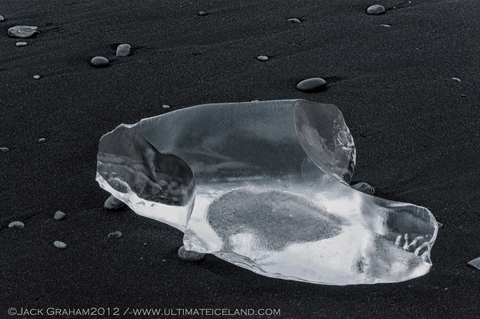 Glacier ice on black beach by jack graham